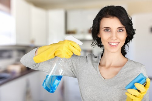 Person blotting a fresh stain on fabric with a clean cloth