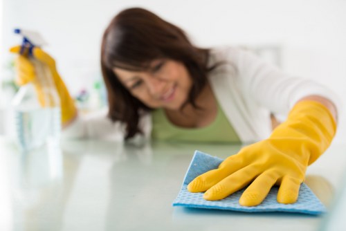 Technician performing steam carpet cleaning in a commercial space
